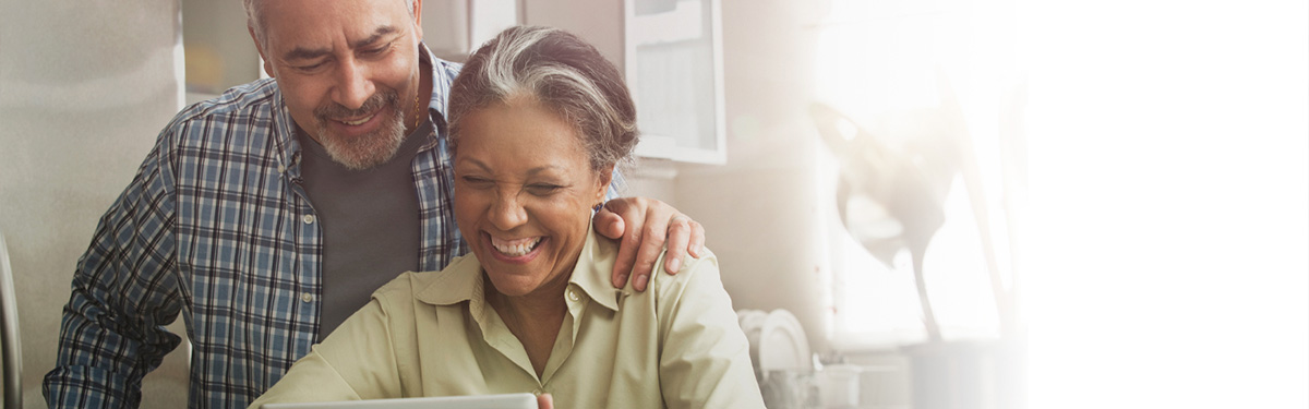 Older couple looking at a tablet together.