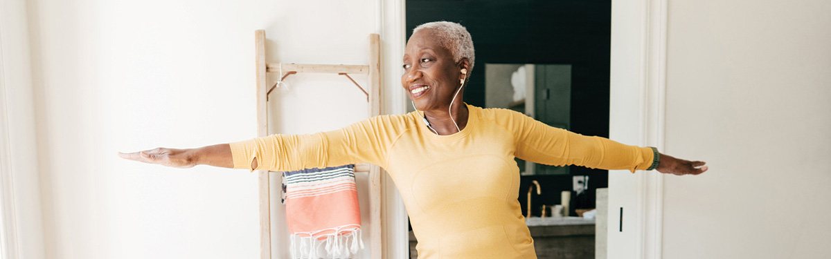 Senior woman doing yoga at home.