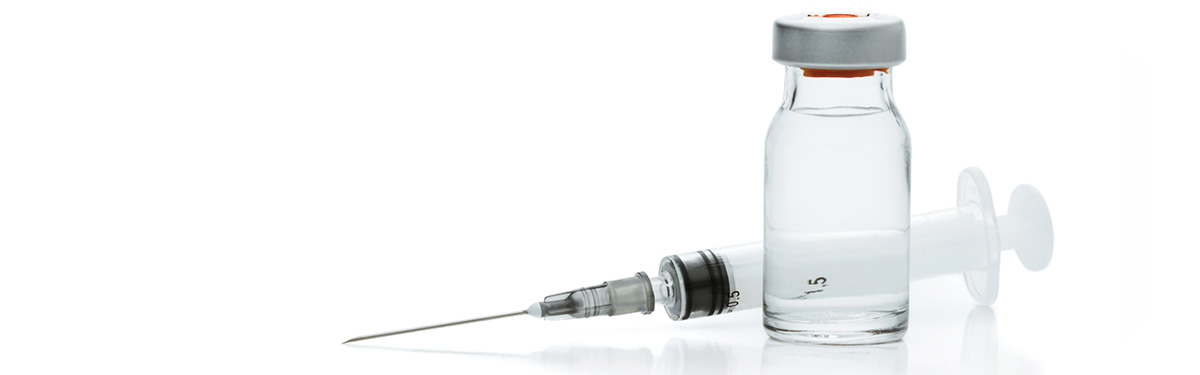 A small bottle of clear liquid and a syringe.